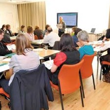 People listening to a presentation in a conference room